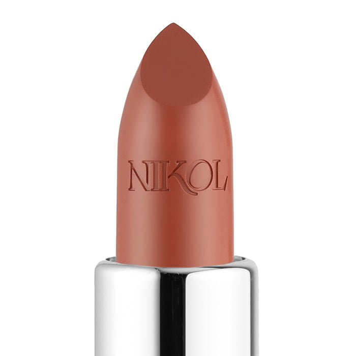 A close-up of the creamy 1975 Shiny Velvet Cream Lipstick #9 in a smooth brown-beige by Nikol Beauty, embossed with NIKOL. Its gleaming silver base and pointed tip ensure a perfect, cruelty-free pout.