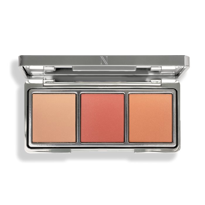 Discover the sleek silver After Glow Blush Palette by Nikol Beauty, featuring three rectangular pans in peach, coral, and orange shades. Crafted with natural ingredients, it imparts a luminous finish for a radiant glow.