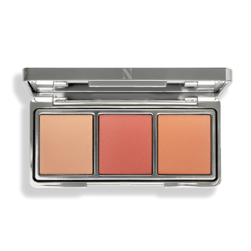 Discover the sleek silver After Glow Blush Palette by Nikol Beauty, featuring three rectangular pans in peach, coral, and orange shades. Crafted with natural ingredients, it imparts a luminous finish for a radiant glow.