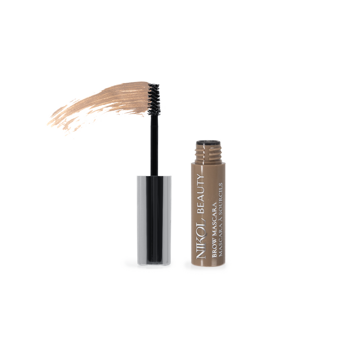 A tube of Nikol Beautys Brow Mascara, featuring high pigmentation, is open on a plain background. The brush, coated with light brown mascara, lies beside it. A smear shows the color and texture ideal for defining eyebrows.