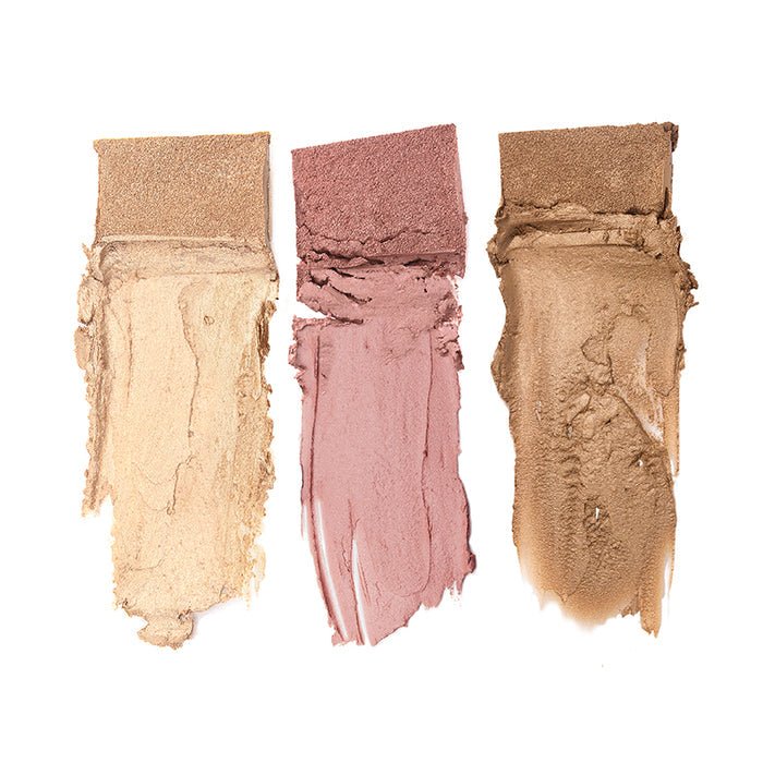 Three swatches from the Nikol Beauty Classic Beach Glow Palette are smeared on a white background. From left to right, they feature light beige, dusty rose, and warm brown shades with a matte texture. Each is crafted using Hot-Pour Technology for smooth application with visible brush strokes.