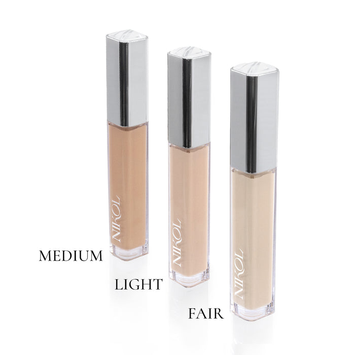 Three bottles of liquid foundation, labeled Medium, Light, and Fair, are arranged vertically against a white background. Each has a silver cap and clear body displaying various shades. Enhance your look with Nikol Beautys Creamy Concealer for flawless coverage that embodies Clean Beauty.
