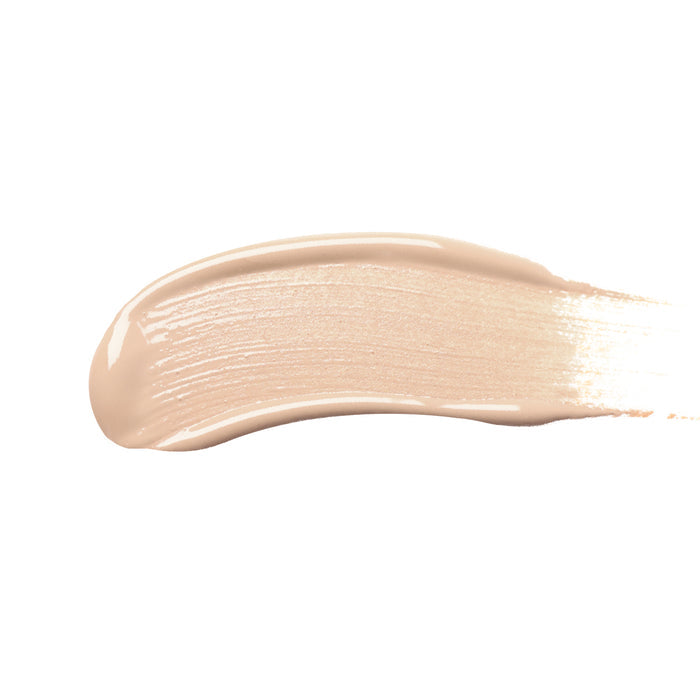 A smooth, light beige swatch of Nikol Beautys Creamy Concealer with a shiny finish spreads horizontally on a plain white background, offering high coverage for clean beauty enthusiasts.