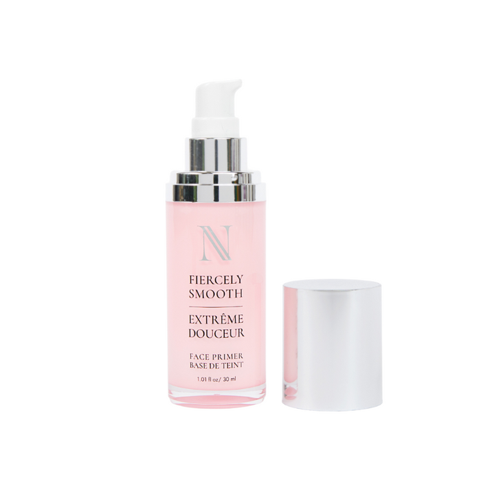 A Nikol Beauty face primer bottle with a pump and silver cap, labeled Fiercely Smooth by Fiercely Smooth Face Primer, contains pink liquid for smooth makeup application. The label also reads Extrême Douceur and Face Primer Base de Teint, highlighting its silicon-free formula.