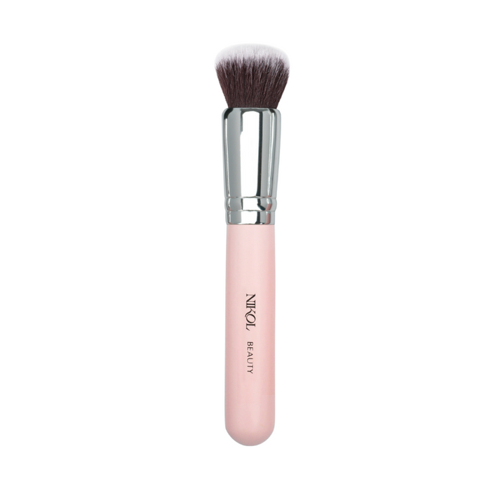 The Foundation Buffing Brush by Nikol Beauty, featuring a stylish pink handle and silver ferrule, offers dense, soft bristles for flawless foundation application. Displayed on a white background, it combines both functionality and elegance.