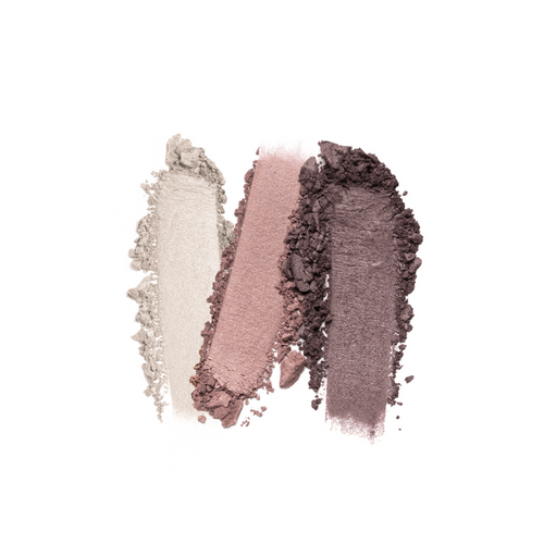 Three swatches from the Nikol Beauty Fresh Beauty 3-Well Eyeshadow Palette in silver, pink, and dark purple are lined up on a white background. The soft, velvety textures offer long-wearing colors with a vegan formula for lasting beauty.