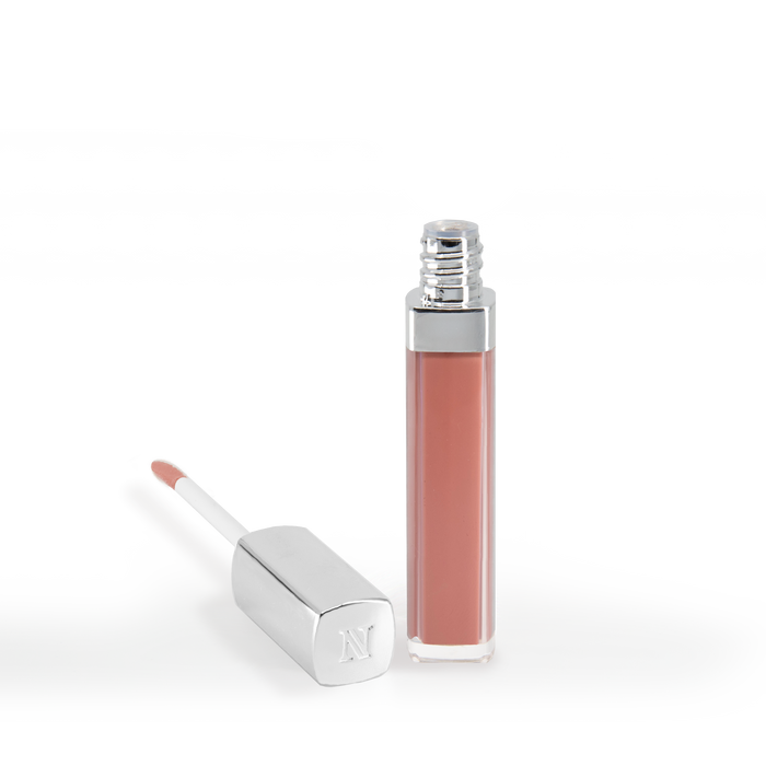 The Good Vibes Lip Gloss #443 by Nikol Beauty stands upright in a clear tube with a silver cap. Beside it, an applicator with a silver handle lies on its side, showcasing a dab of the high-impact shine gloss. The background is white.