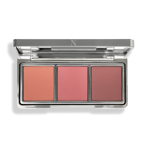 Explore the In Full Bloom Blush Palette from Nikol Beauty, featuring peach, pink, and mauve blushes in a silver compact with a reflective lid. Made with natural ingredients for a luminous finish and stunning glow every time.