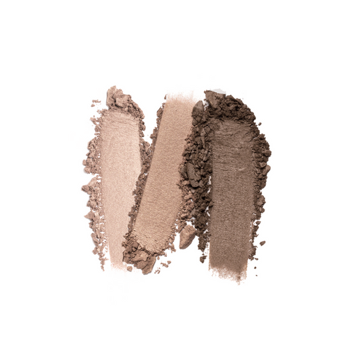 Three overlapping swatches of brown makeup powder in light to dark shades are smeared on a white background, showcasing the texture and pigmentation of Nikol Beautys Le Bottled Blonde 3-Well Eyeshadow Palette, a clean beauty must-have with a vegan formula for a guilt-free glow.