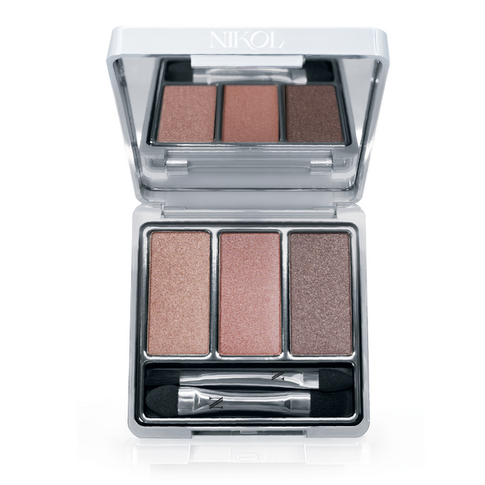 The Naughty Nancy 3-Well Eyeshadow Palette by Nikol Beauty features shimmery, long-wearing peach, pink, and bronze shades plus a dual-ended applicator in a silver compact labeled “NIKOL.”.
