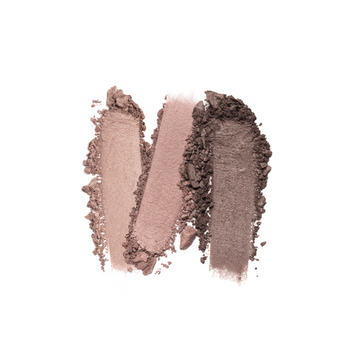 Three swatches of Nikol Beautys Naughty Nancy 3-Well Eyeshadow Palette, featuring shades from light to dark brown, are displayed side by side on a white background. Their vegan formula ranges in texture from smooth to rough, highlighting the powdery consistency.
