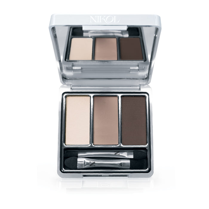 The Nikol Beauty Rewrite The Rules 3-Well Eyeshadow Palette features beige, taupe, and dark brown silky pans enriched with shea butter for smooth application. Housed in a silver compact with a hinged lid, it includes a dual-ended applicator.