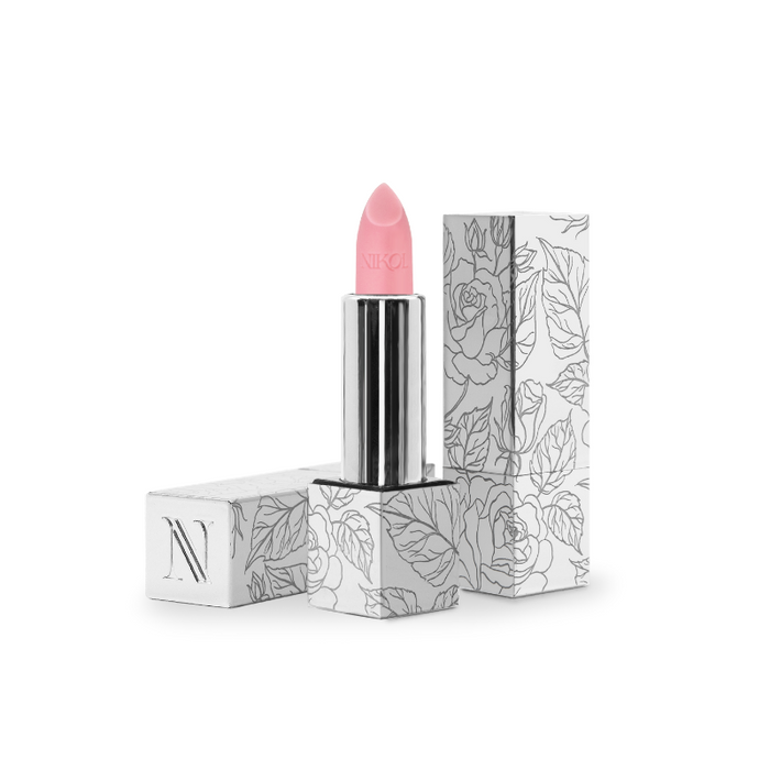 Rose Lip Balm #100 by Nikol Beauty comes in a pink hue encased in a sleek silver tube, housed within a floral-patterned white box adorned with N. This vegan product also functions as a hydrating balm for smooth, moisturized lips all day.