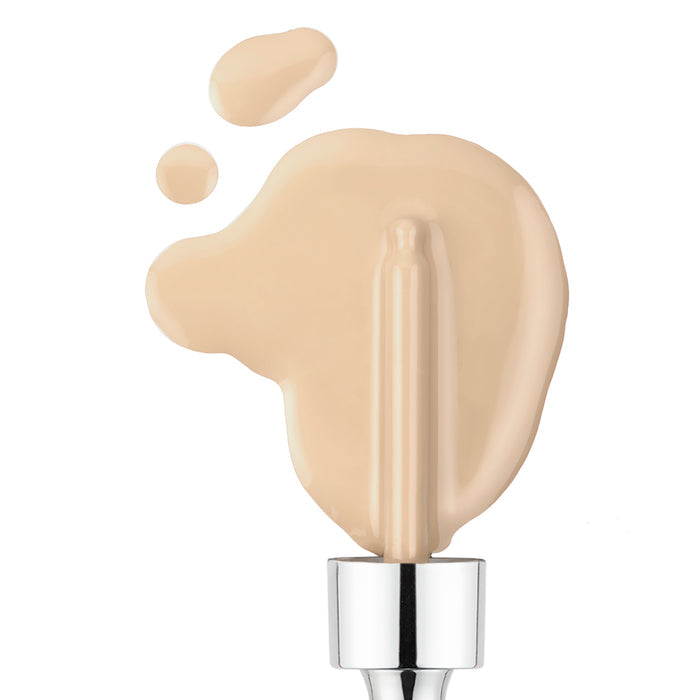 A few drops of Nikol Beauty Serum Foundation in creamy light beige are spilled beside a silver applicator wand on a pristine white background. This clean beauty formula offers customizable coverage and effortlessly enhances your natural radiance.