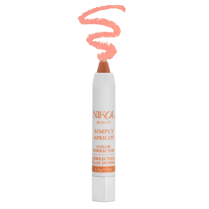 The Nikol Beauty Simply Apricot lip crayon features a white and peach design and a swirl of peach color, ideal for brightening under-eye discoloration on medium skin tones.
