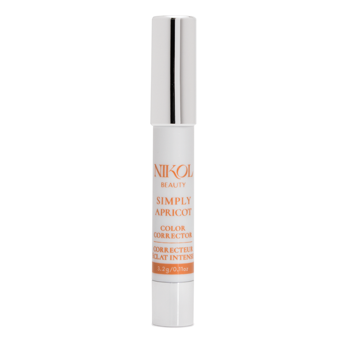 A white and silver tube labeled Nikol Beauty Simply Apricot stands upright on a white background, ideal for medium skin tones and brightening under-eye discoloration.