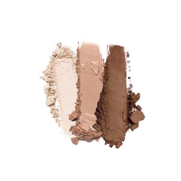 The Strong Brew 3-Well Eyeshadow Palette by Nikol Beauty displays three swatches on a white background: light beige, soft pink, and deep brown shades. The finely milled texture highlights their smooth pigmentation for perfect matte eyeshadows.