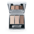 Introducing The Cabana 3-Well Eyeshadow Palette by Nikol Beauty, a vegan set featuring light beige, medium tan, and dark brown shades. It comes with a dual-ended applicator and sleek silver packaging with a clear top for brand display.