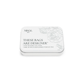 A rectangular white tin labeled "These Bags Are Designer-Eye Mask" by Nikol Beauty contains a reusable, medical-grade silicone eye mask with a floral design and bilingual English/French text.