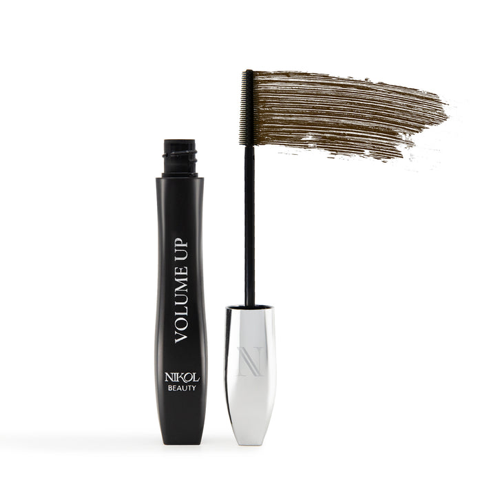 A black tube of Nikol Beauty VOLUME UP Mascara stands upright with its silver cap and wand removed, revealing a swipe of brown mascara above the brush on a white background.